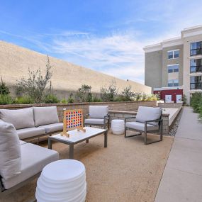 Outdoor lounge seating with games at The Huntington luxury apartments in Duarte, CA