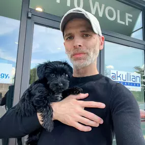 Rich Akullian and Studio A's main dog Molly pose outside of 110 Wolf Road in Albany, NY where Studio A (Akullian Creative's home studio) is located.