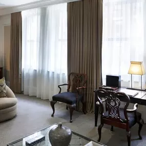 Beacon Hill Studio Room - Approximately 485 square feet with a luxurious sitting area and views of historic Beacon Street. In front of the fireplace – a love seat or two comfortable arm chairs with an ottoman,