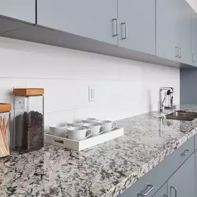 Breckenridge white background with light blue undertones. There is a blend of clear and milky quartz running throughout, as well as crystal chips comprised of mica, which add an element of sparkle to the slab.