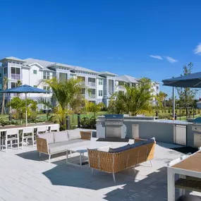 BBQ Grills and Lounge Area at The Gallery at Trinity Luxury Apartments in Trinity, FL