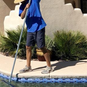 Tucson Pool and Spa team member cleaning the pool