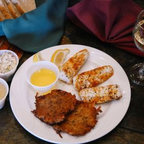 Baked Cod and Homemade potato pancakes at Tail Feathers Bar & Grill Friday Fish Fry in Lake Geneva, WI