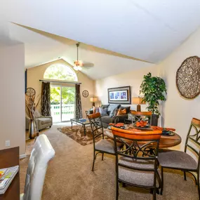 Gorgeous Modern Living Room with Elegant Crown Moulding and Wood Burning Fireplaces (in Select Units) at Pointe Royal Townhome Apartments