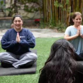 Shaded outdoor patio with open space, used for mindfulness and yoga therapy sessions.