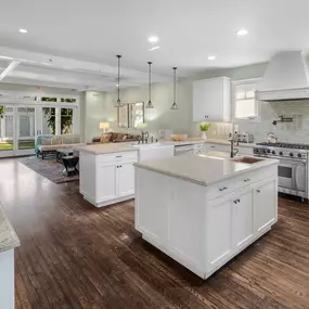 Bright white kitchen and dining area with large table and natural light, part of Clearview’s residential mental health program.