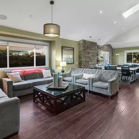 Spacious living and activity room with couches, tables, and natural light in Clearview’s dual diagnosis residential housing.
