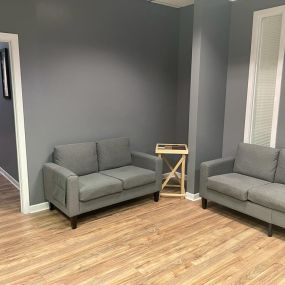 Ayudando a la Comunidad- grey couches inside office