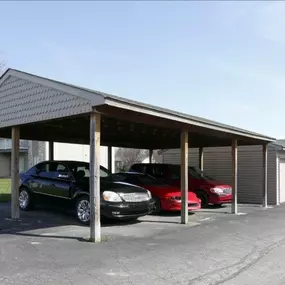 Covered carport and individual garage units at The Park at Greenhill, providing residents with shaded parking and secure storage options within the apartment community.