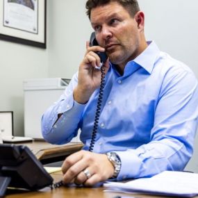 Personal injury lawyer, Alex Silkman talking on the phone with an insurance company