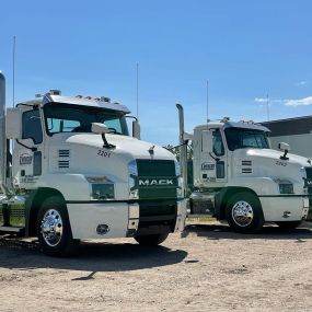 Two white Mack Anthem daycabs sold by RDO Truck Center in Fargo, ND.