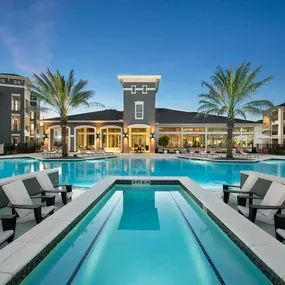 Pool surrounded by clubhouse and buildings