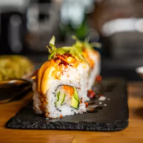 The YOSHIMITSU Cut Roll - Hamachi, Avocado, Cucumber, Gobo | Krab, Spicy Mayo, Brulee Sweet Soy, Crunchy Garlic, Green Onion.