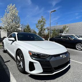 white Audi parked in front of dealership