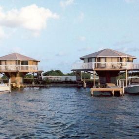 Cantilevered over the water’s edge and overlooking the Caribbean Sea on a small private Cay in Belize, these Topsider hurricane-resistant pedestal homes make for the perfect tropical vacation getaway.