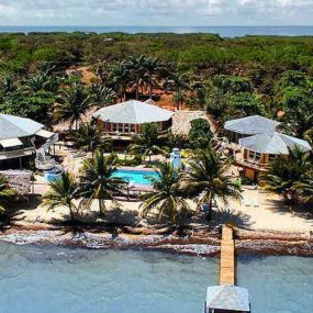 Magnificent panoramic views of the Caribbean Sea highlight this secluded small Topsider resort on the Placencia Peninsula in southern Belize.