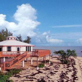 Built on an oceanfront point on North Andros in the Bahamas, this piling home was designed and engineered to be low-maintenacne and hurricane resistant.