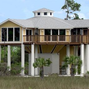 A literal “battleship” of a structure, this hurricane-resistant home was engineered to survive hurricane-force winds, and was elevated nearly 20-ft for storm surge protection.