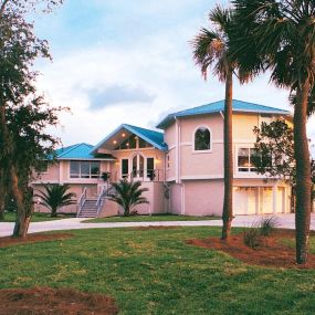 This coastal South Carolina hurricane-resistant home was built on concrete piers with the ground level area enclosed. “Flood vents” at ground level allow storm surge water to flow through without degrading the structural integrity of the house.