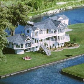 This luxurious, one-of-a-kind, custom-designed contemporary lake house built on Lake St. Clair in Michigan, features two elevated living levels with extraordinary panoramic lake views.