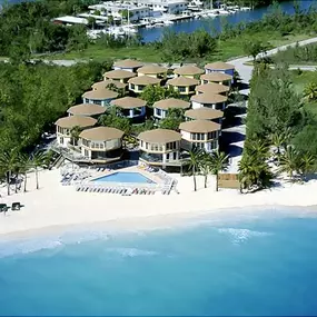 Topsider early-era Florida Keys beach resort. Each villa is elevated with two living levels and an enclosed screened lanai. These homes, built facing the Atlantic, were designed to be hurricane resistant