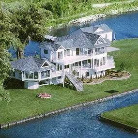 This luxurious, one-of-a-kind, custom-designed contemporary lake house built on Lake St. Clair in Michigan, features two elevated living levels with extraordinary panoramic lake views.