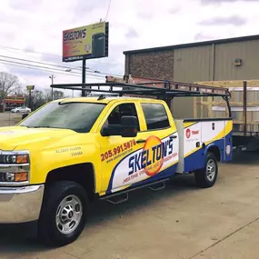 Skelton's Heating, Cooling & Plumbing work truck in the field