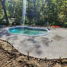 Concrete patio installation around the pool