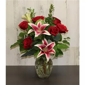 All aglow with botanical beauty and just right for expressing cherished thoughts. 6 roses arranged with everyone's favorite lily is sure to bring everyday smiles! Our florists hand-design each arrangement. We strive to send the freshest flowers: to ensure lasting beauty, some flowers may arrive in bud form and will fully bloom over a few days. The benefit is that they will last longer for the recipient to enjoy! In the event we are sold out of this container, we will substitute one of equal or h