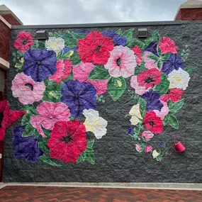 Have you visited The Wave Petunia Mural yet? Located on the corner of State Street and N. River Street in downtown Batavia, IL. The mural is created by local artist Angie Maioriello a self-taught freelance illustrator and muralist based in the northwest suburbs of Chicago.