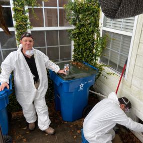 Two Local Electrician technicians working in the crawlspace of a home