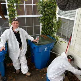 Two Local Electrician technicians working in the crawlspace of a home