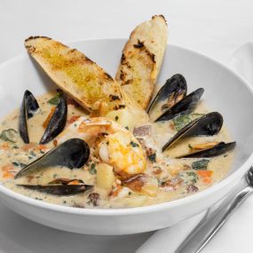 Made to Order  Seafood Chowder with Mussels, chopped clams, fresh fish, shrimp, roasted garlic cream, potatoes, carrots, bacon, okra, caramelized onions