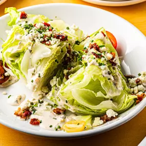 Wedge salad with crispy bacon, point reyes blue, tomato, ranch