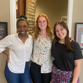 Cesia and Shea welcoming our newest team member, Lily!