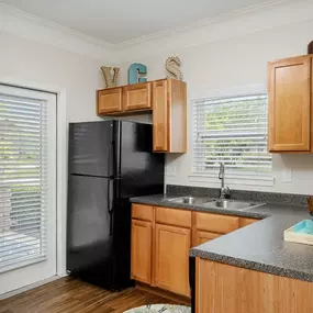 Gourmet Kitchens with G.E. Black Appliances and Maple Raised-Panel Cabinetry at Legends at Villas at Carrington Square Apartments