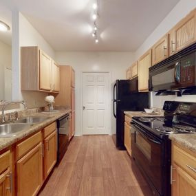 Gorgeous renovated kitchens available with updated counters and cabinetry at Parc 1346 Apartments