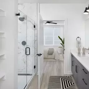 Ensuite Bathrooms with Quartz Countertops, Wood-Style flooring, and Standing Shower in Select Floorplans