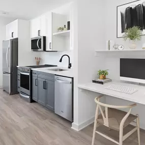 Kitchen and built-in desk in studio apartment home at Camden Village District apartments in Raleigh, NC