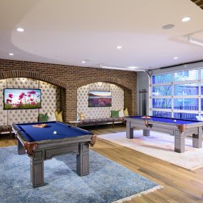 Bar area with HDTV wall and two billiards tables