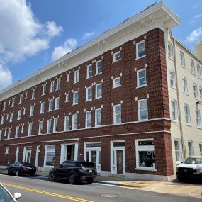 front of a 4-story brick building for sale with NAI Commercial Real Estate