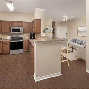 Kitchen and living room with wood-style flooring at Camden Addison