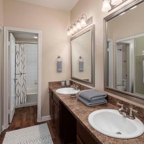 Bathroom with double sink vanity and framed bathroom mirrors