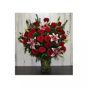 What's better than a dozen roses? How about two dozen roses…vivid and vivacious in this beautiful arrangement along with stargazer lilies, myrtle, lily grass, salal and tree fern in a graceful vase. Please note, our florists hand-design each arrangement; colors, varieties, balloon styles, and containers may vary due to local availability. We strive to send the freshest flowers: to ensure lasting beauty, some flowers may arrive in bud form and will fully bloom over a few days. The benefit is that