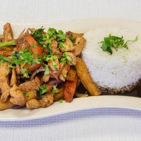 Peruvian style stir-fried  Chicken sautéed with onions, tomatoes, Tumi fries, and our mind-blowing signature Lomo Sauce served with a side of  White rice.
