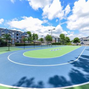 Lighted Tennis Court with Adjacent Sports Court at Sugarloaf Crossing Apartments