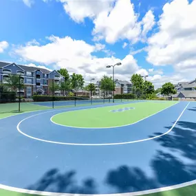 Lighted Tennis Court with Adjacent Sports Court at Sugarloaf Crossing Apartments