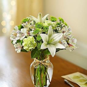 Bring peace and serenity to someone special in your life. Inspired by the quiet beauty of nature, our soothing arrangement is hand-designed with the freshest blooms in delicate shades of green and white and arranged in a classic gathering vase tied with raffia. Just one look will have them smiling and reflecting on your thoughtfulness!