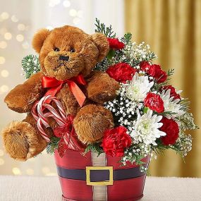 Wish them a warm and wonderful holiday season with this fun 2-in-1 surprise! Our signature Lotsa Love® plush bear arrives in a merry red Santa belt tin surrounded by a festive mix of mini red carnations, white cushion poms and more, including a trio of candy canes.