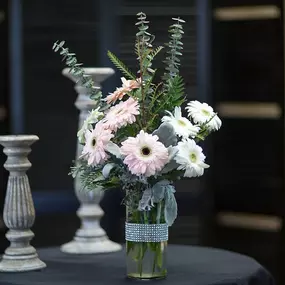 Send this bedazzled arrangement of pink and white gerberas designed in a accented jeweled vase. Available in a array of colors, call us and we can get your desired color